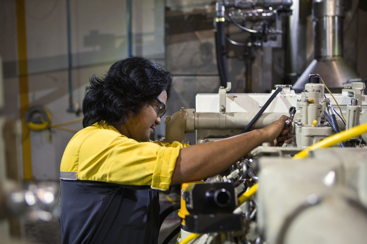 Technician serving a Cat® Marine Engine