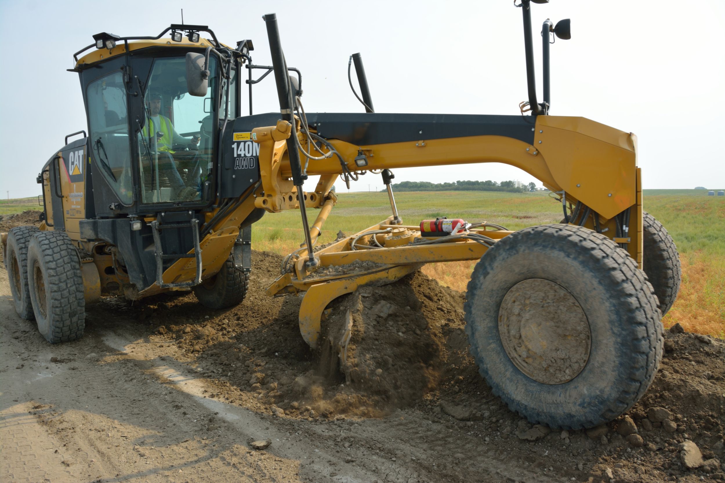 A Cat<sup>®</sup> 140M Motor Grader is at work at one of Loenbro’s job sites.