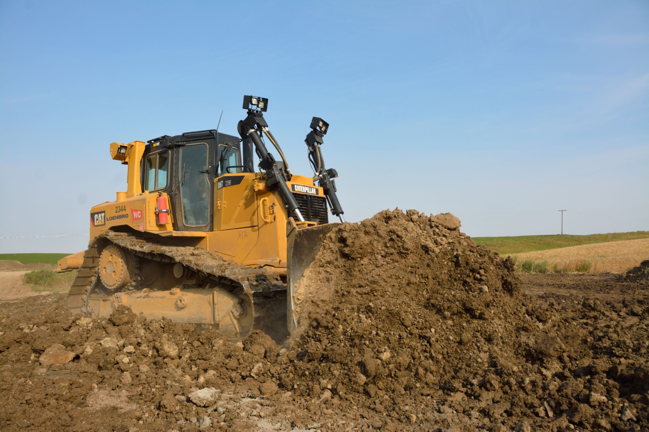 A Cat<sup>®</sup> D6T Dozer pushes dirt at one of Loenbro’s job sites.