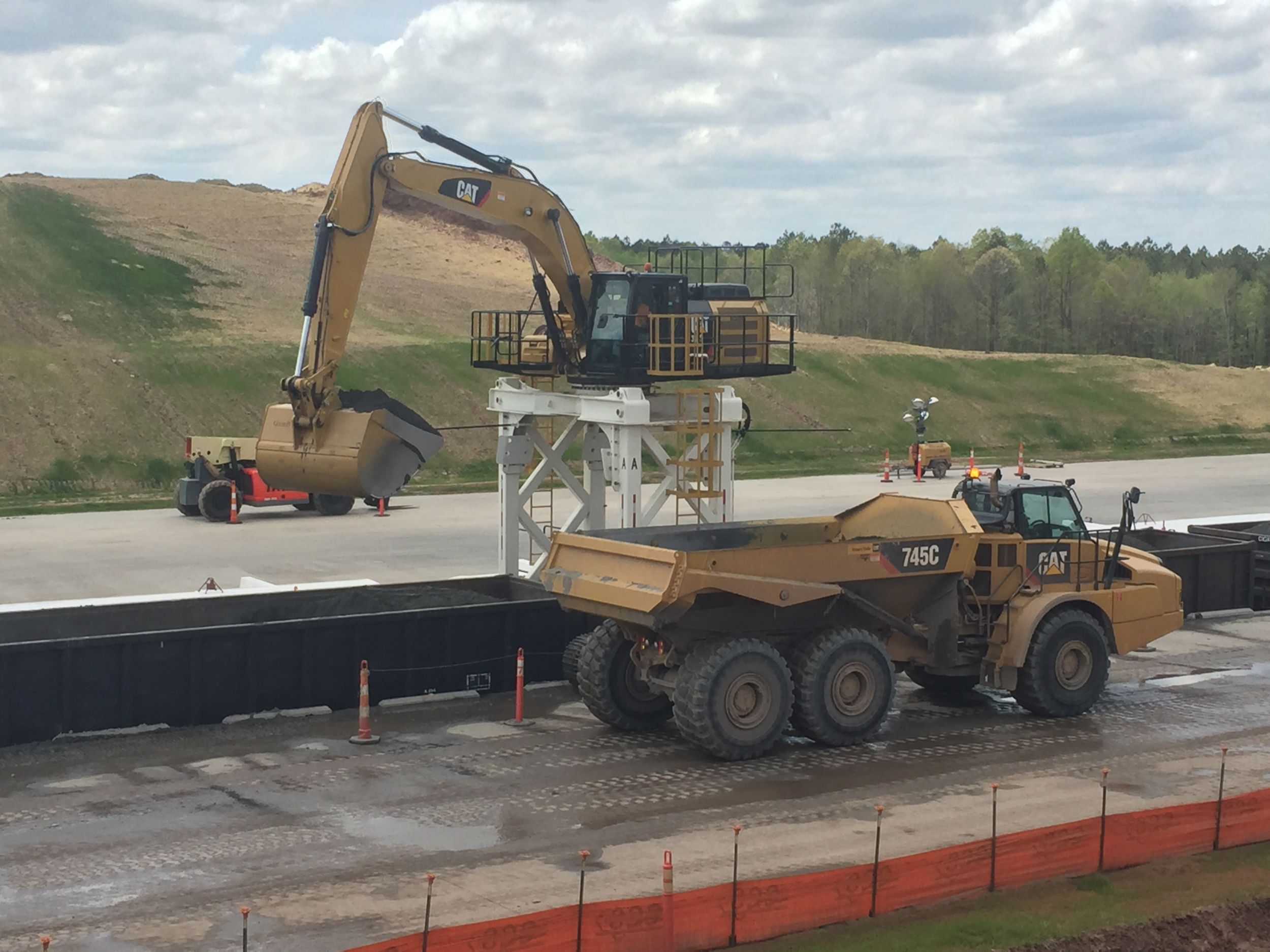 Charah uses special Cat<sup>®</sup> 336 excavators on straddle carriers and Cat 745 trucks to load and haul ash.