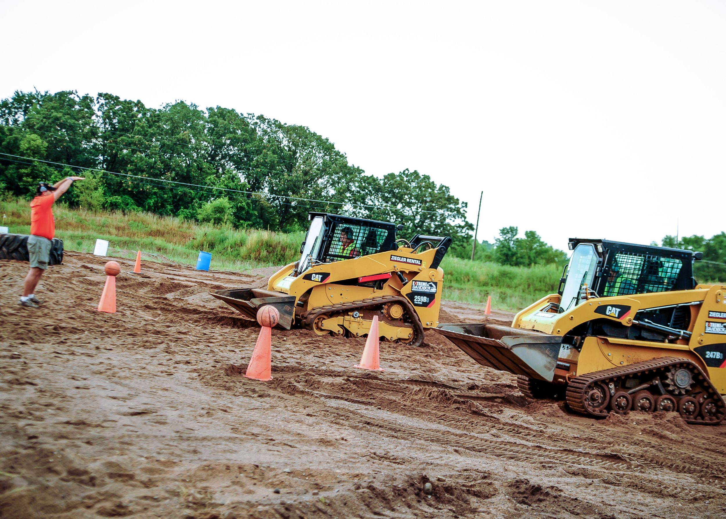 Two Multi Terrain loaders line up to try the sandbox course.