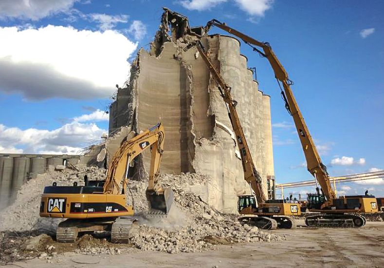 Cat® Material Handlers Tearing Down Silos on a Demolition Site