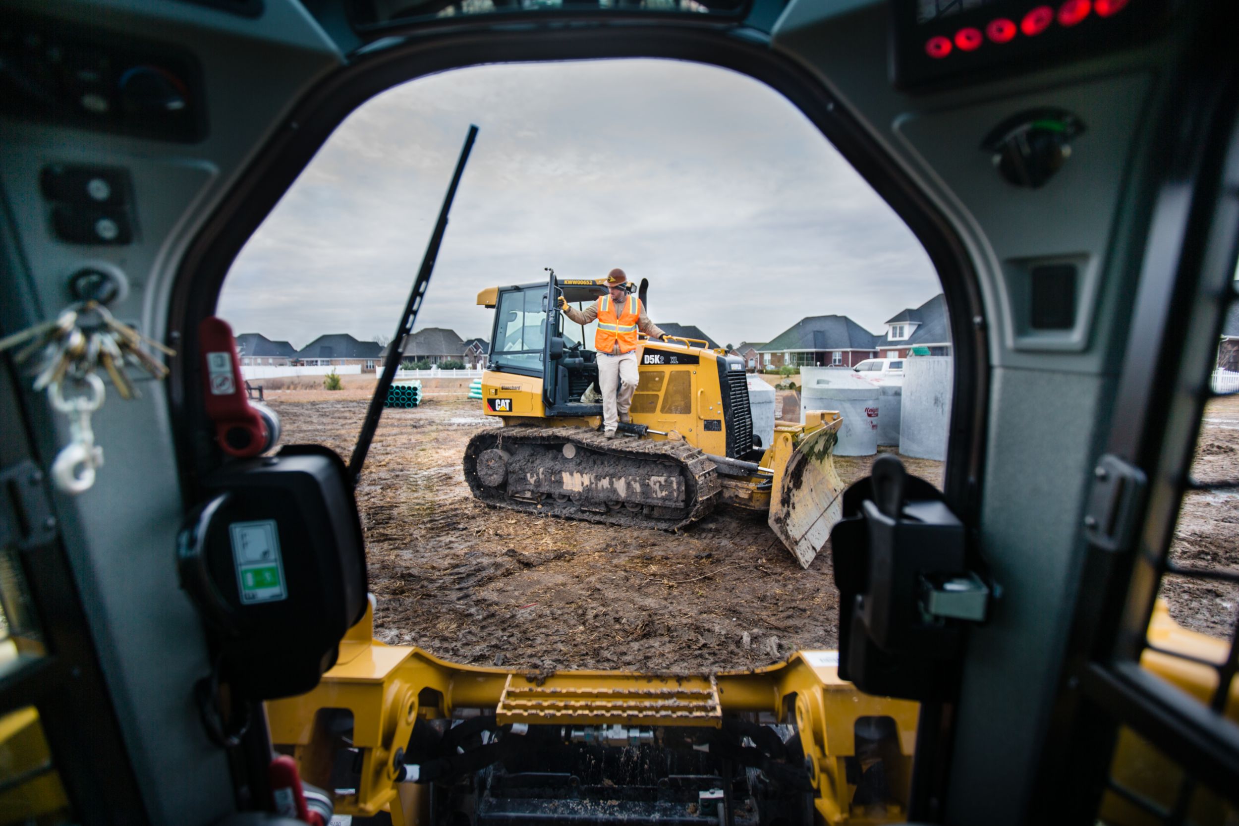 Looking out from the cab of a skid steer, the operator can clearly see the D5K dozer in front of him. Both machines are critical for Chipley Company.