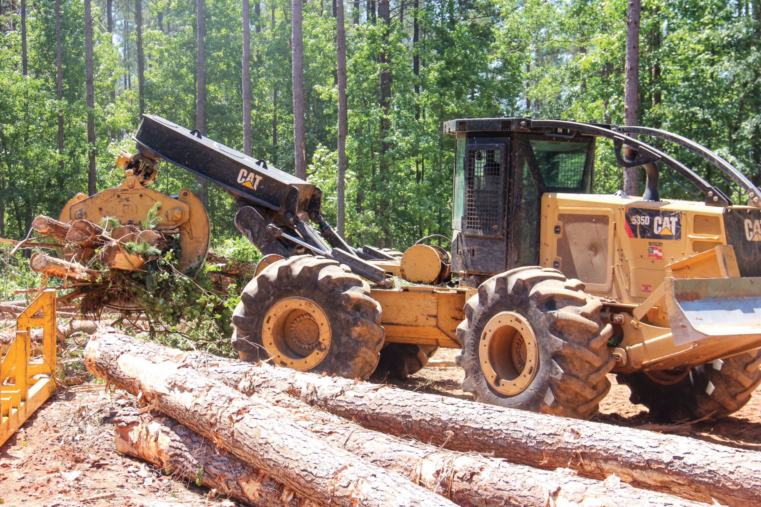 A Cat® skidder pulls to the loading deck.