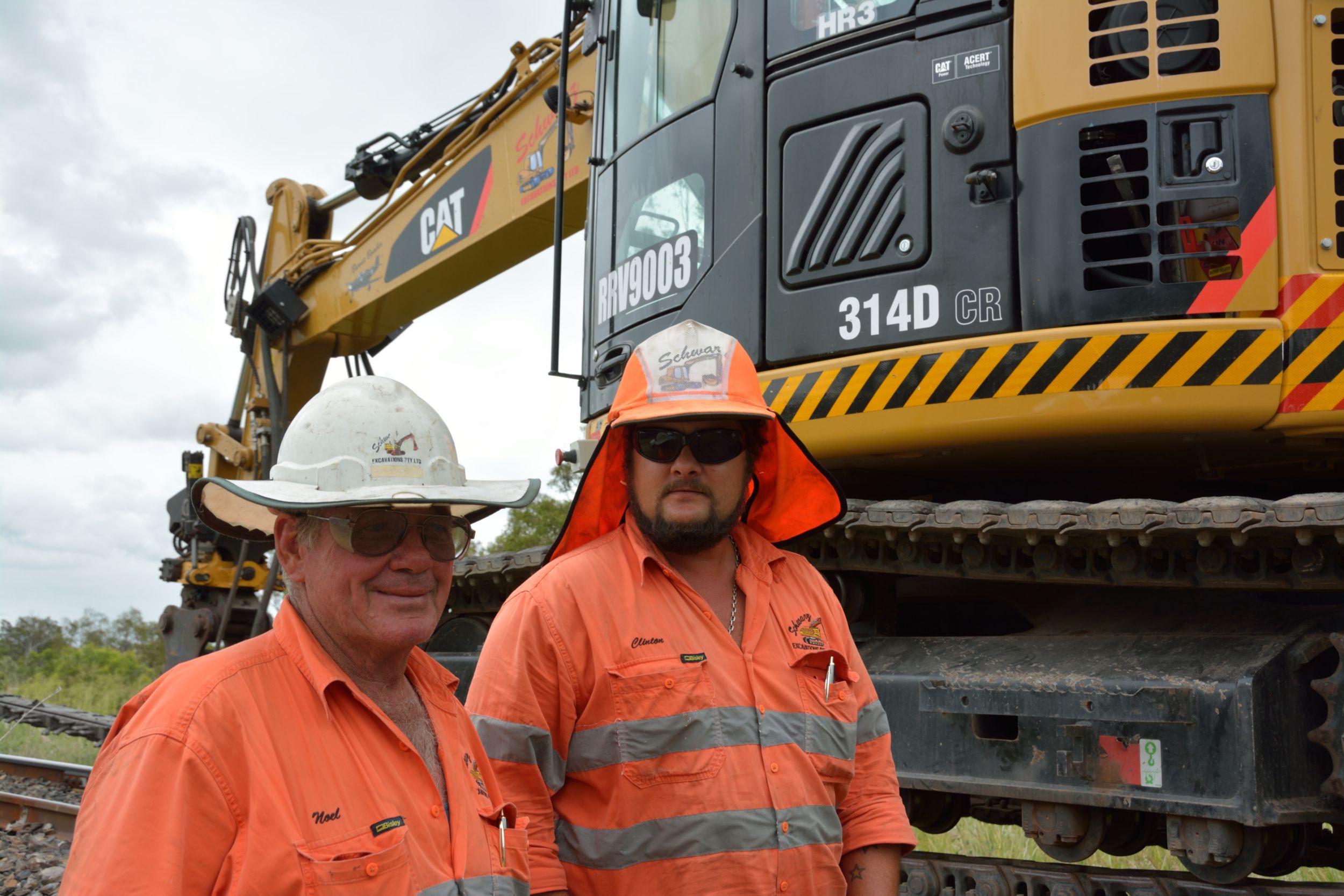 Noel Schwarz, Managing Director of Schwarz Excavations PTY LTD, stands with a machine operator in from of one their RMT14Ds.
