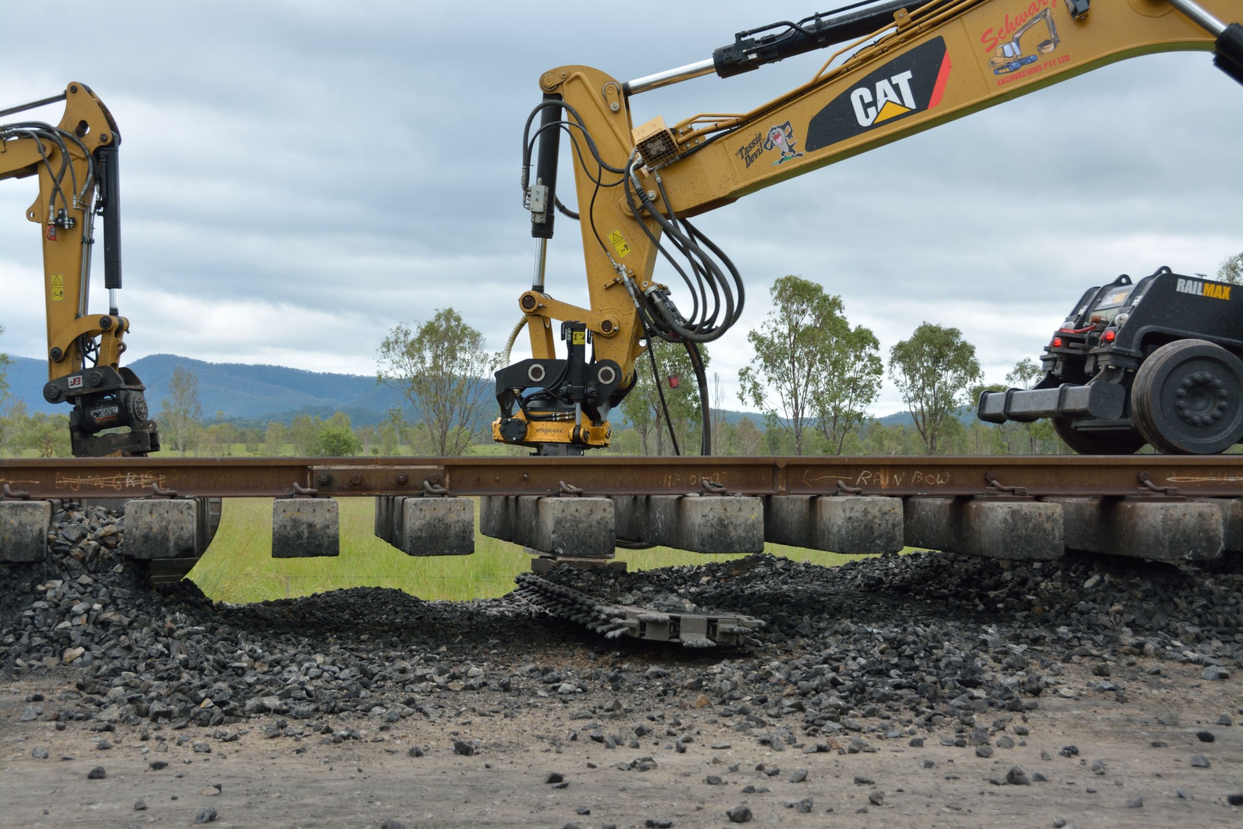 The cutter bar easily swings out and underneath the section of suspended track to be repaired.