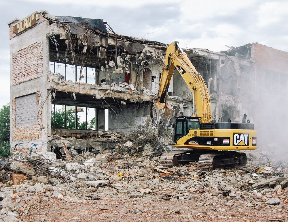 Adamo Group uses bigger iron, like the 345C hydraulic excavator, to tear down large structures safely and efficiently.