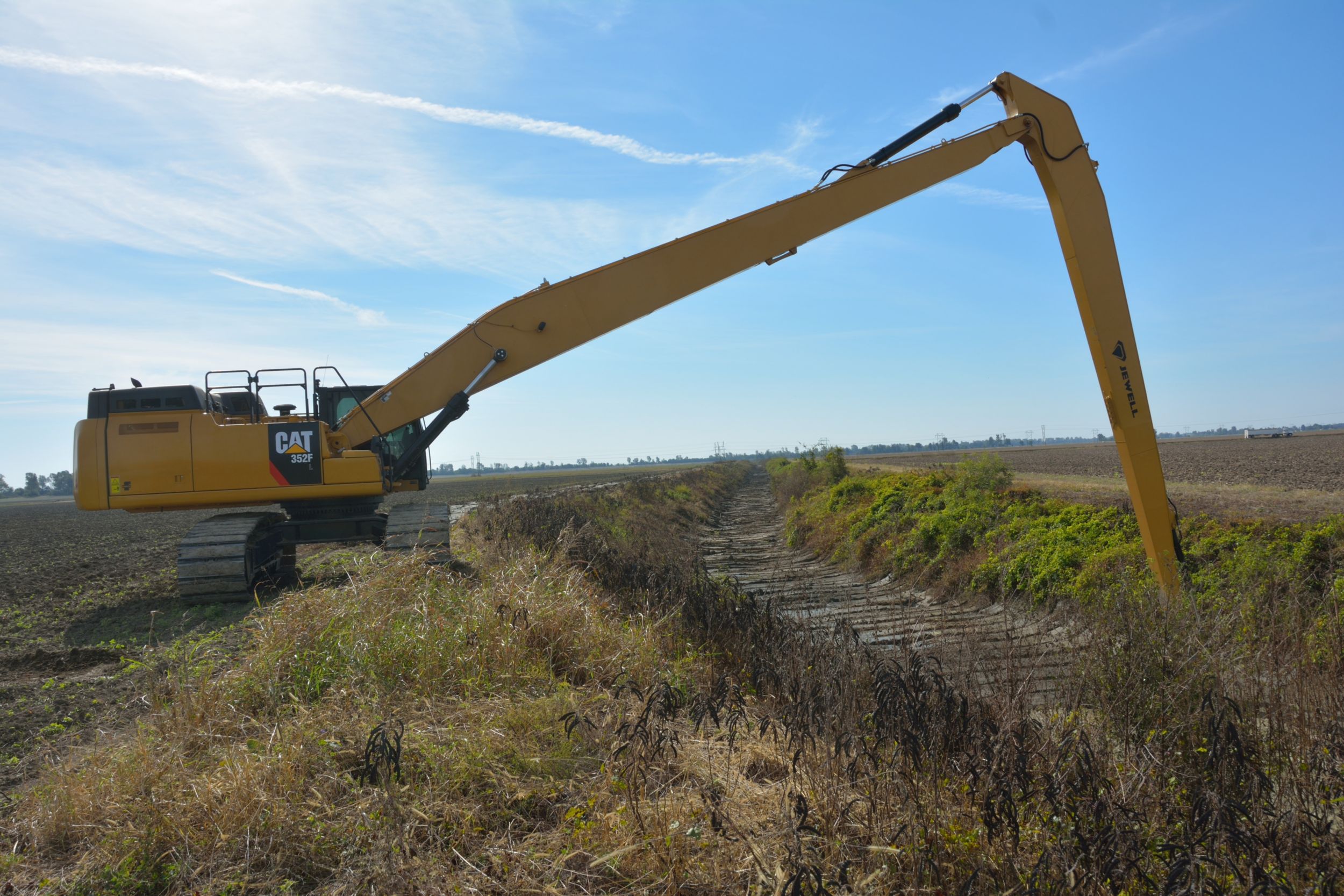 Drainage ditches are maintained by Cat® hydraulic excavators equipped with long reach booms from 60 to 82 feet in length and fitted with ditch cleaning buckets and/or specialty designed mowers.