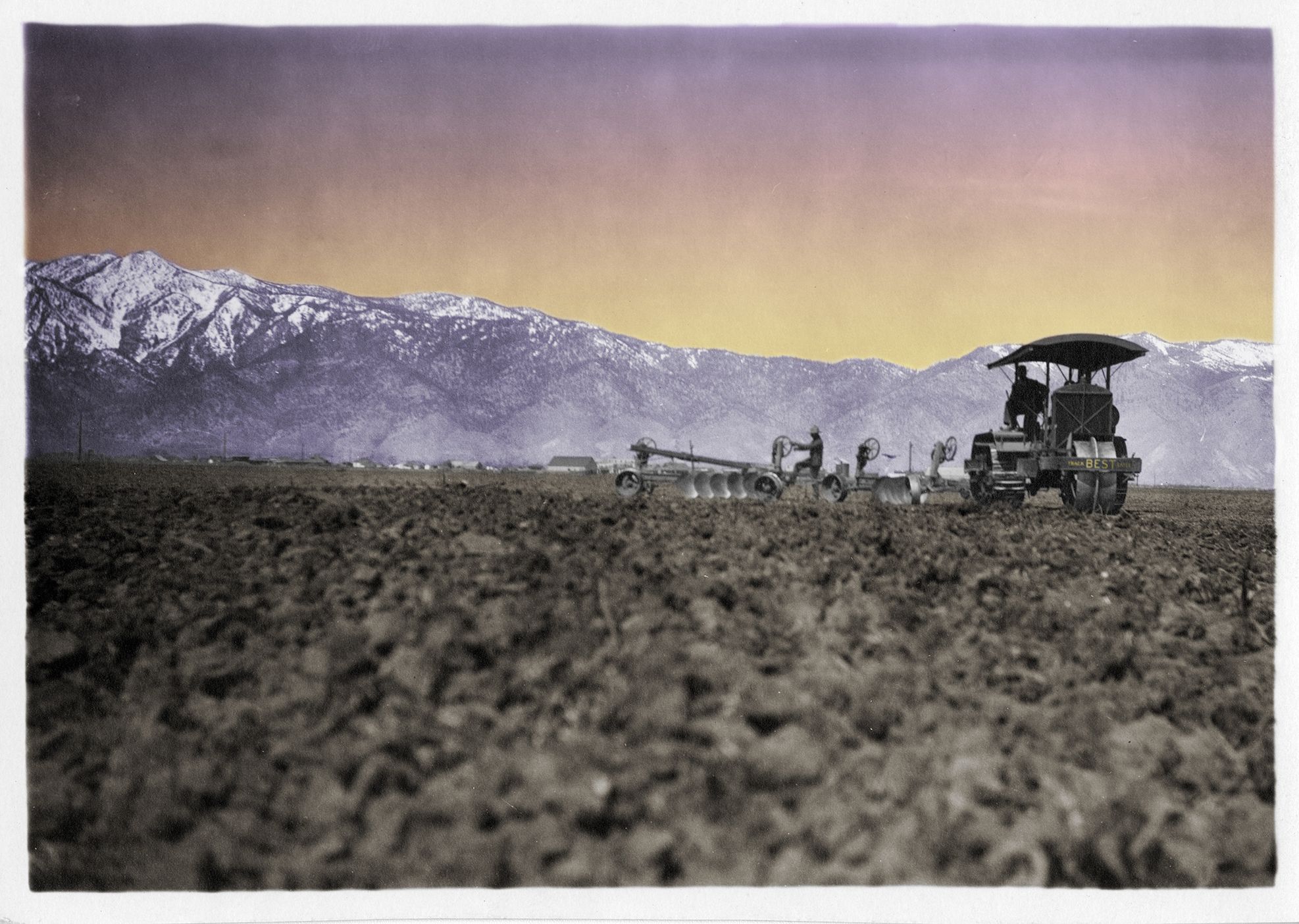Colorized image of Best 75 working near a mountain range.