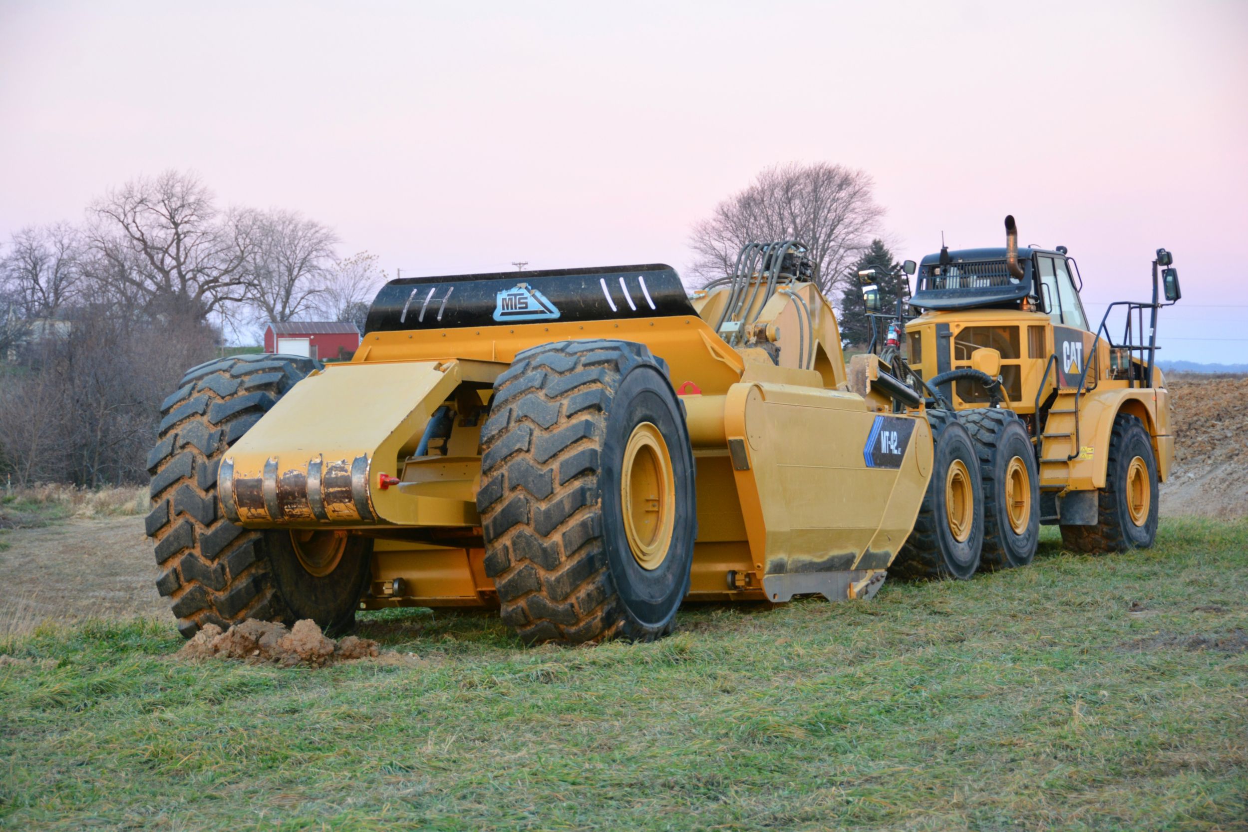 MTS in Elkader, Iowa, manufactures earthmoving equipment to complement the current line of Cat products. MTS builds a variety of pull pan scraper models and construction-grade tractors developed specifically for excavation and grading.