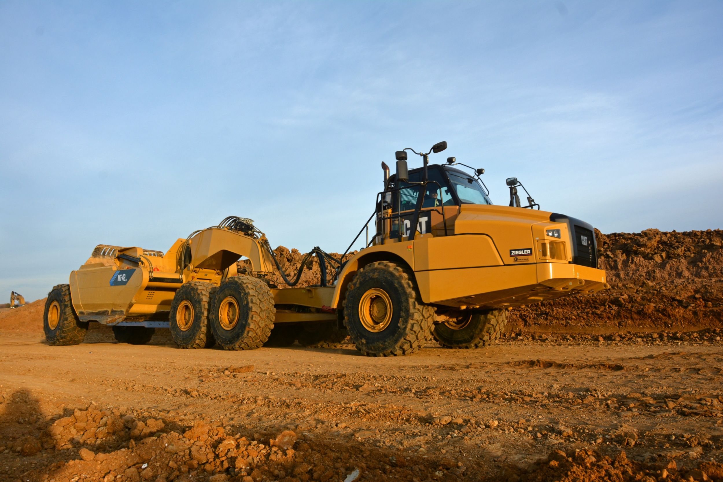 The MTS Articulated Truck and Scraper Pull Pan Combinations being used on the Southwest Arterial are Cat 745C Articulated Trucks that utilize an MTS conversion package for scraper use, and are easily converted back for truck applications.