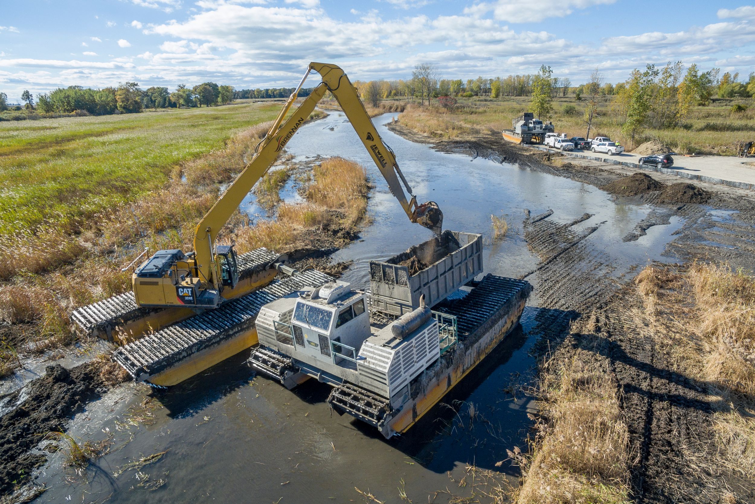 Amphibious excavators enabled the J.F. Brennan Company crew to work with minimum disturbance in areas that were simply too soupy for conventional machines.