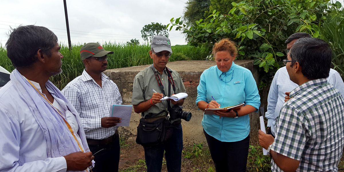 Caterpillar's Jan Kirkton visits Maharashtra villages impacted by government desilting projects with Nature Conservancy and other NGOs.