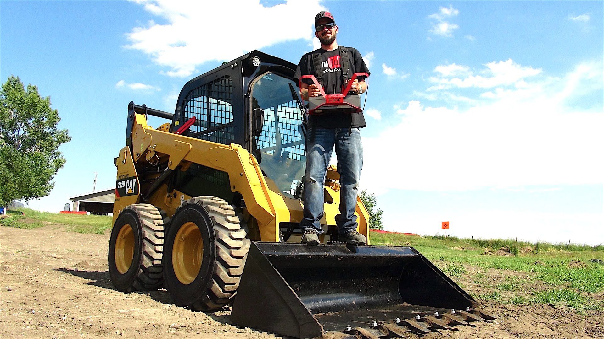 Aaron Bidochka, creator of the RC Sparks Studio YouTube channel, shows off his Cat<sup>®</sup> 242D with RemoteTask™ on his ranch outside of Calgary. 