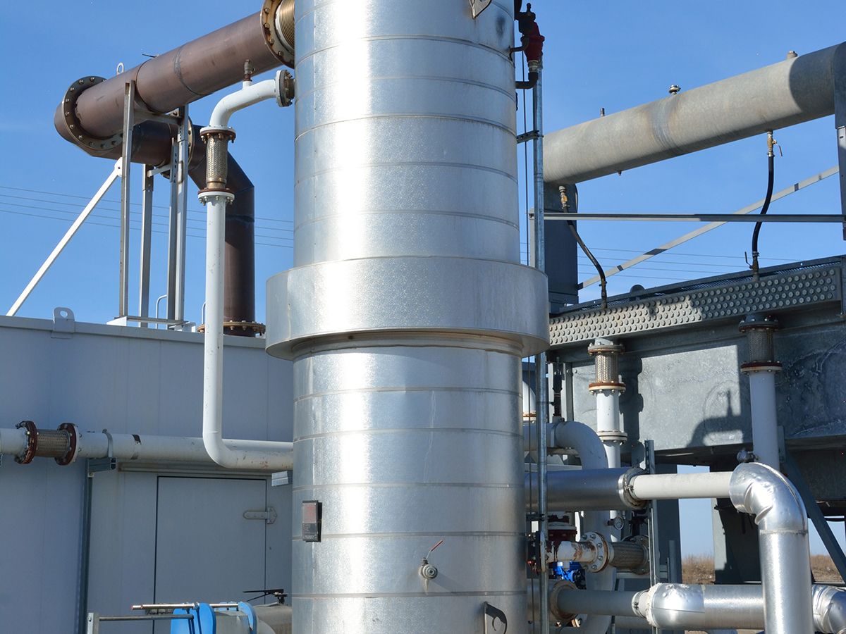 A heat exchanger unit rests on a skid adjacent to the Cat generator enclosure.