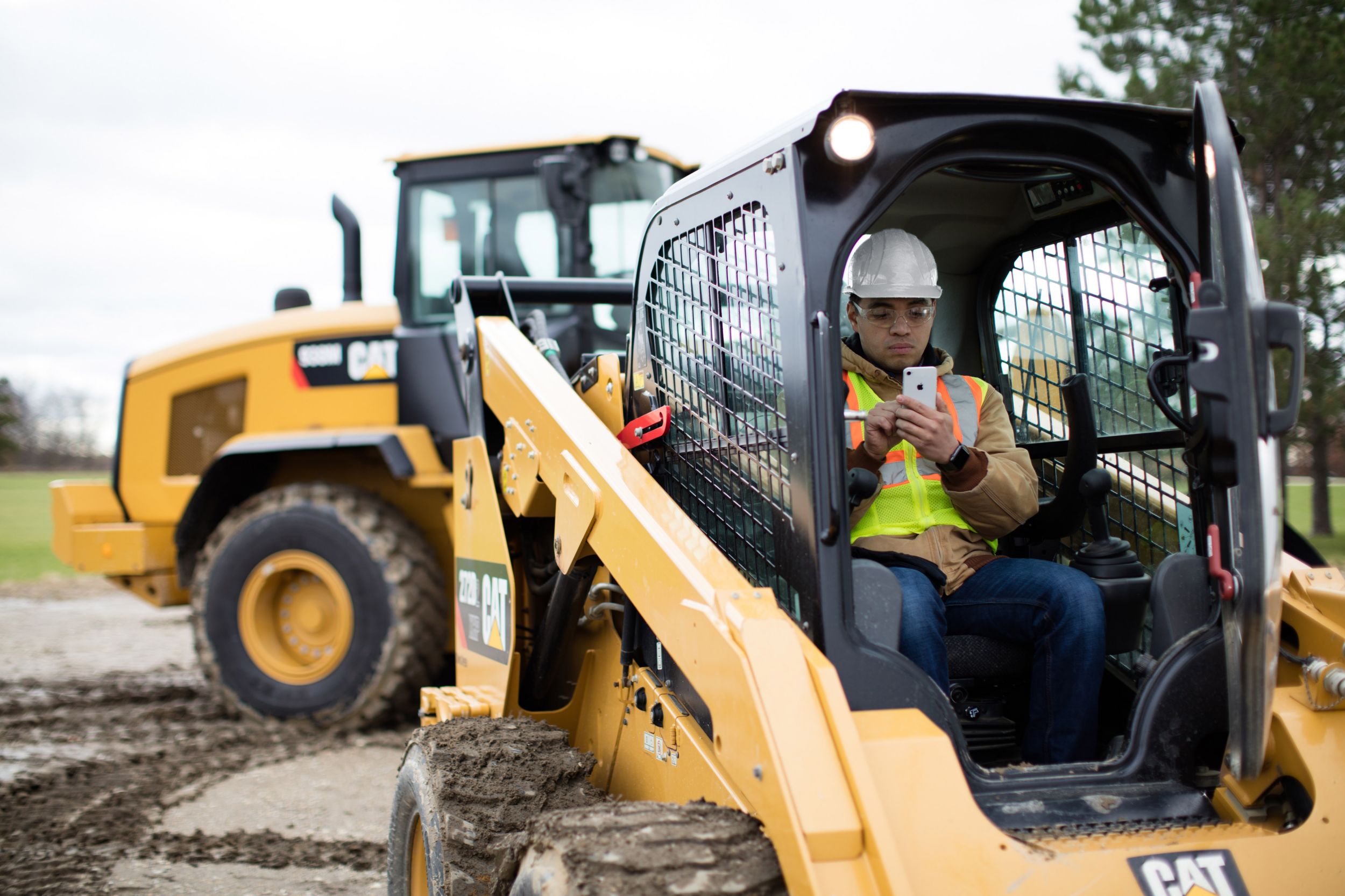 Mobile phone with skid steer and wheel loader