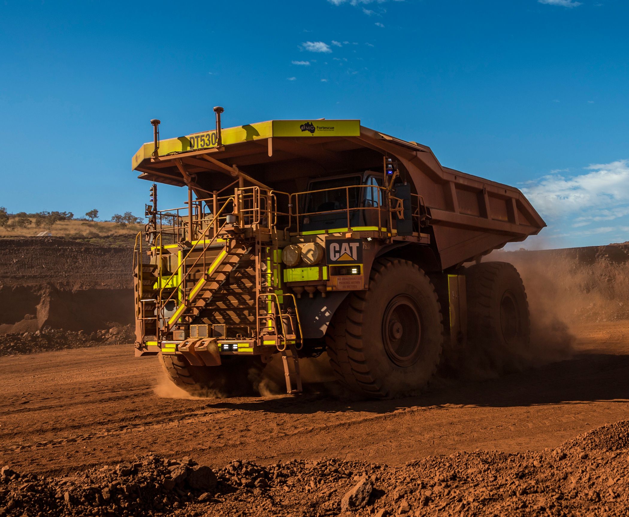 Cat 793F CMD Mining Truck leaving iron ore pit