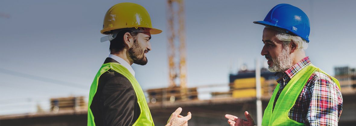 Two people talking at a building site