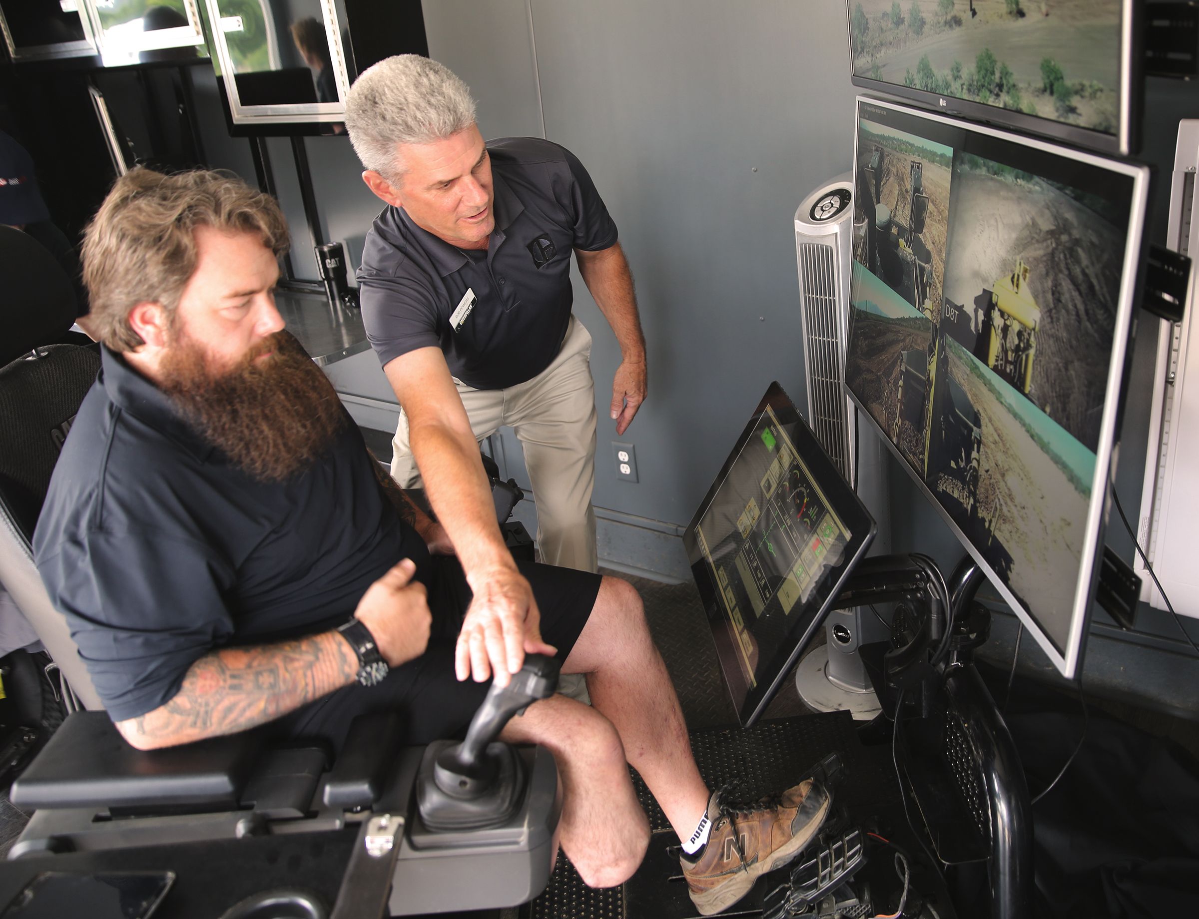 Caterpillar team walks Segs4Vets member through the control system.