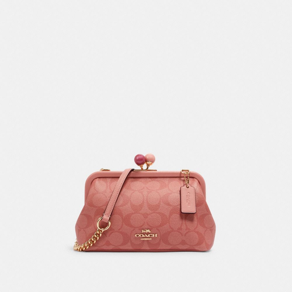 COACH NORA KISSLOCK CROSSBODY IN SIGNATURE CANVAS - IM/CANDY PINK - C1452