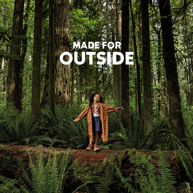 Made for outside. A girl in an adult Silver Ridge shirt in the forest. 