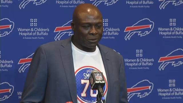 Hall of Famer Bruce Smith, left, a former Buffalo Bill, sits with his wife,  Carmen, and son, Alston, as his jersey number is retired during a halftime  ceremony of an NFL football