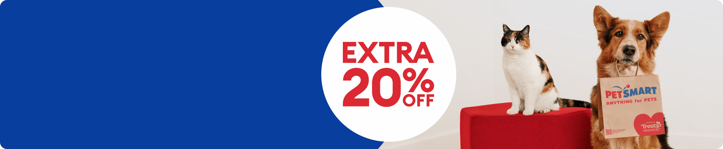 Cat sitting beside a dog holding a PetSmart shopping bag in mouth with EXTRA 20% OFF rotating with 1 DAY ONLY callout