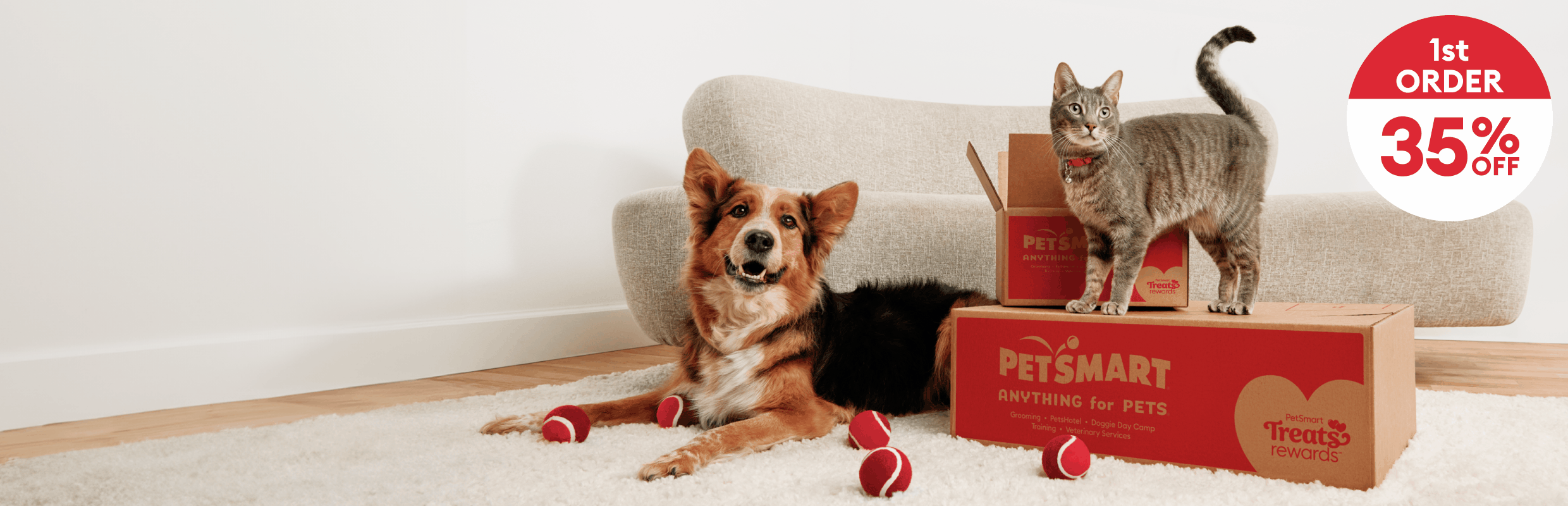 Dog & cat with PetSmart shipping boxes & toys and the callout, 35% off 1st order, 20% off 2nd order, 10% off 3rd order