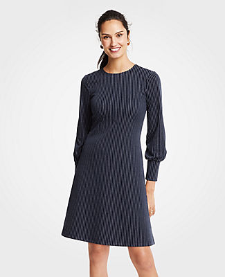 Meet your real-life uniform: this is Luxewear. Every day. Every wear. Rule the day (and night) with our pinstripe dress, highlighted with smartly cuffed sleeves. Jewel neck. Long sleeves with shirred cuffs. Hidden back zipper with hook-and-eye closure.