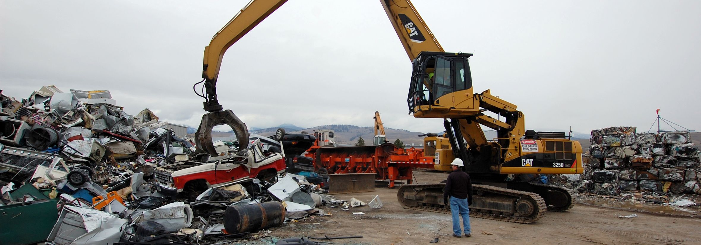 material handler picking up a car