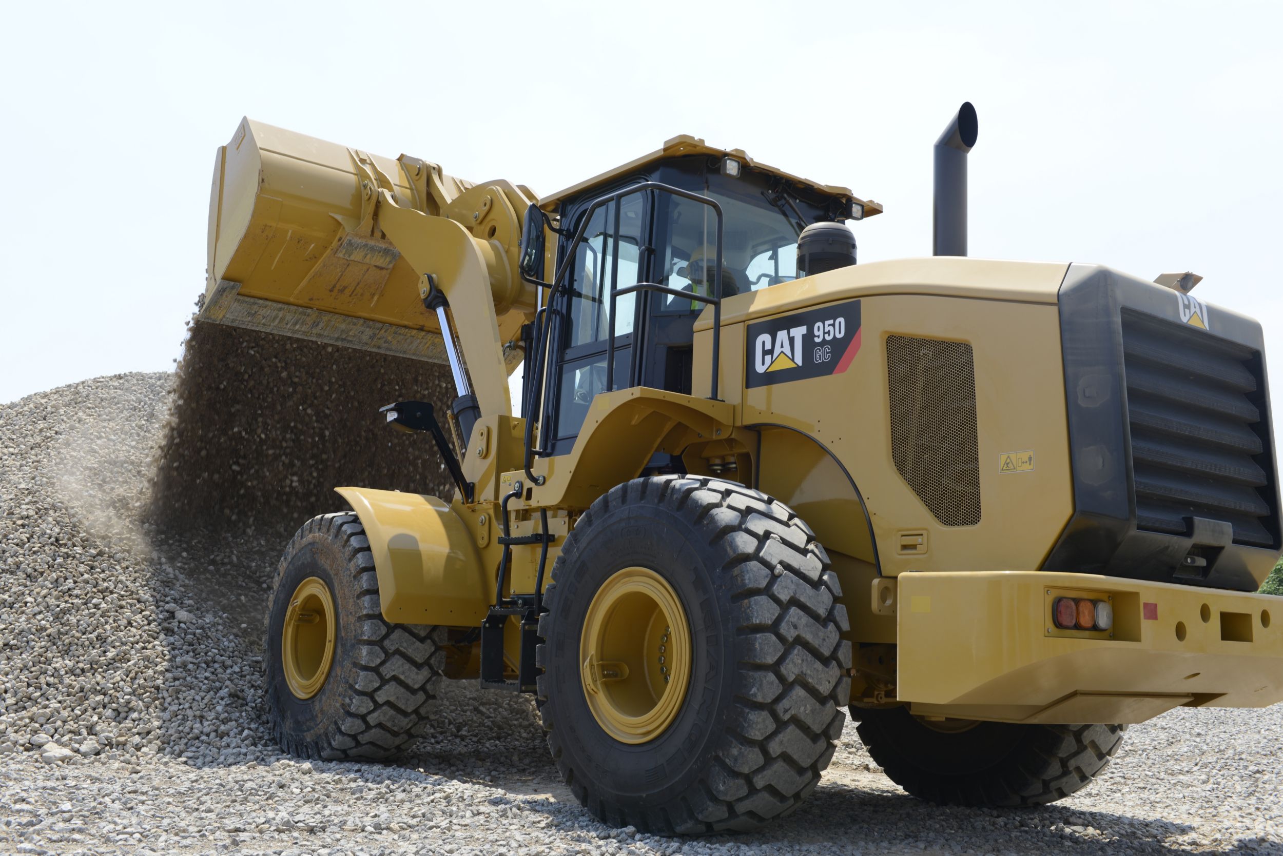 950 GC Medium Wheel Loader Dumping Rock