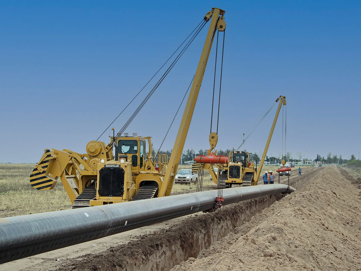 PL83 Pipelayer works in a line to install pipe