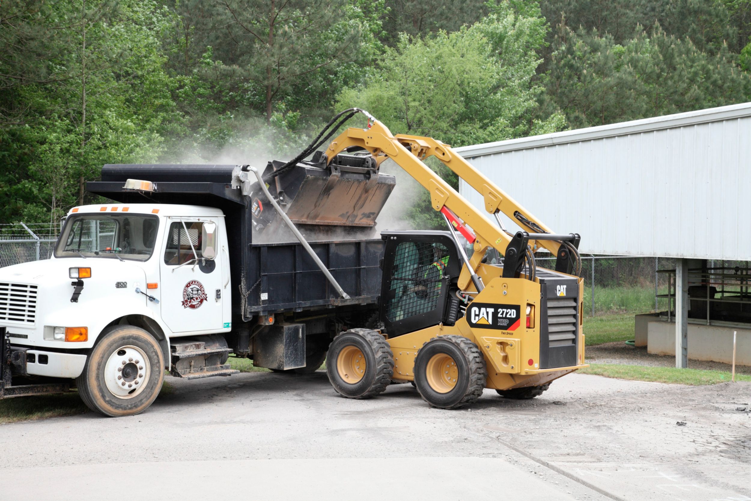 product-Cat® Utility Broom Dumping Debris into waiting Dump Truck