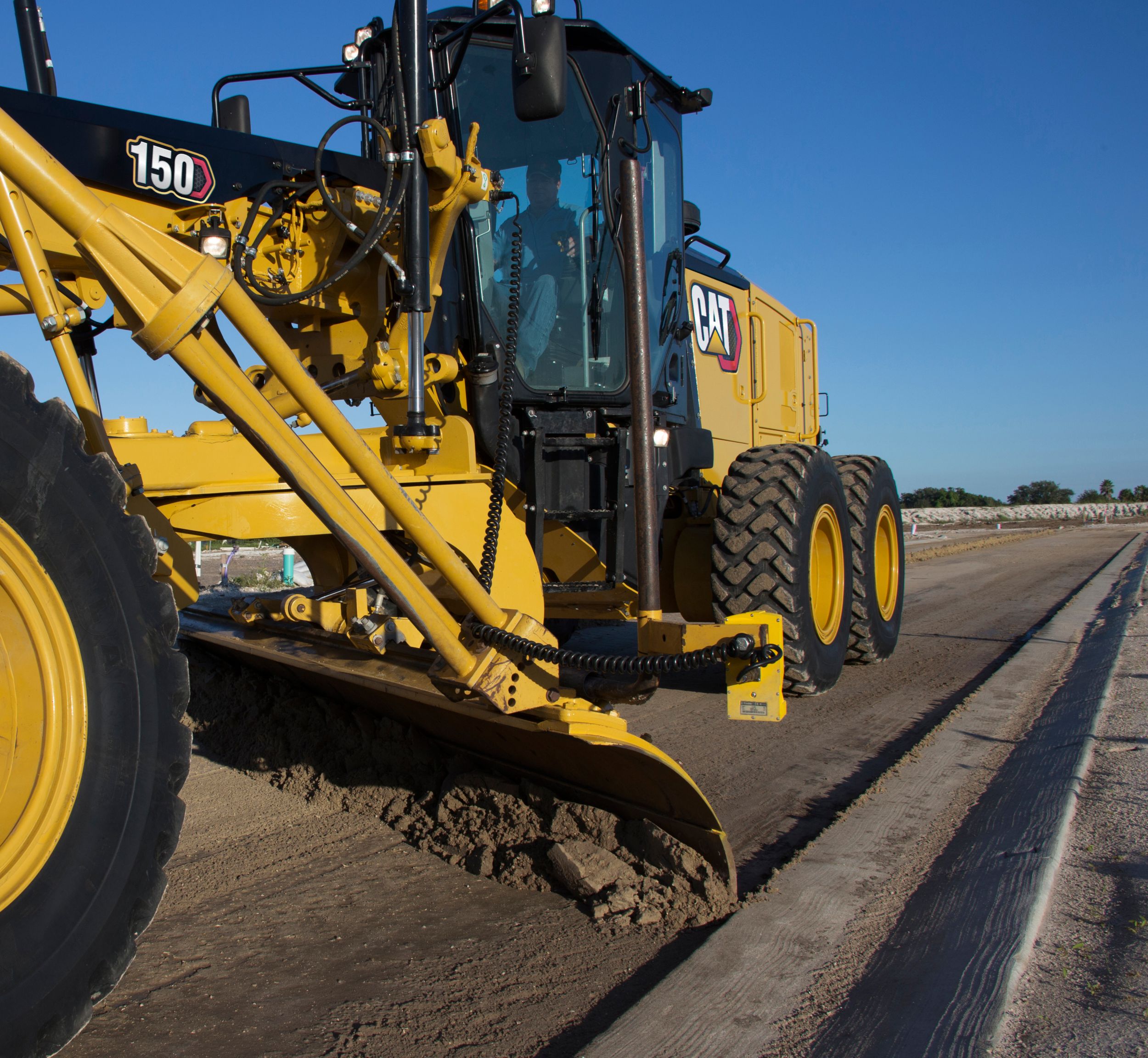 150 Motor Grader fine grading by curb