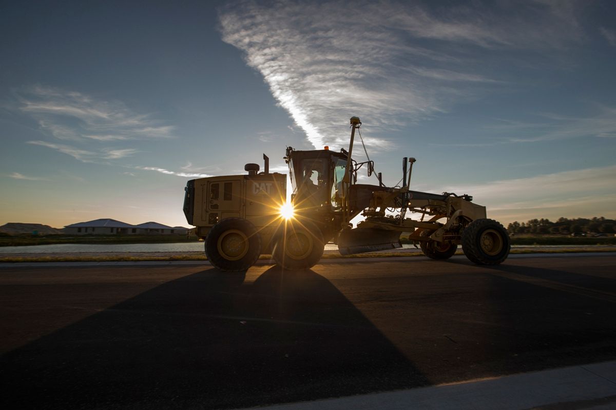 150 Motor Grader working at sunset