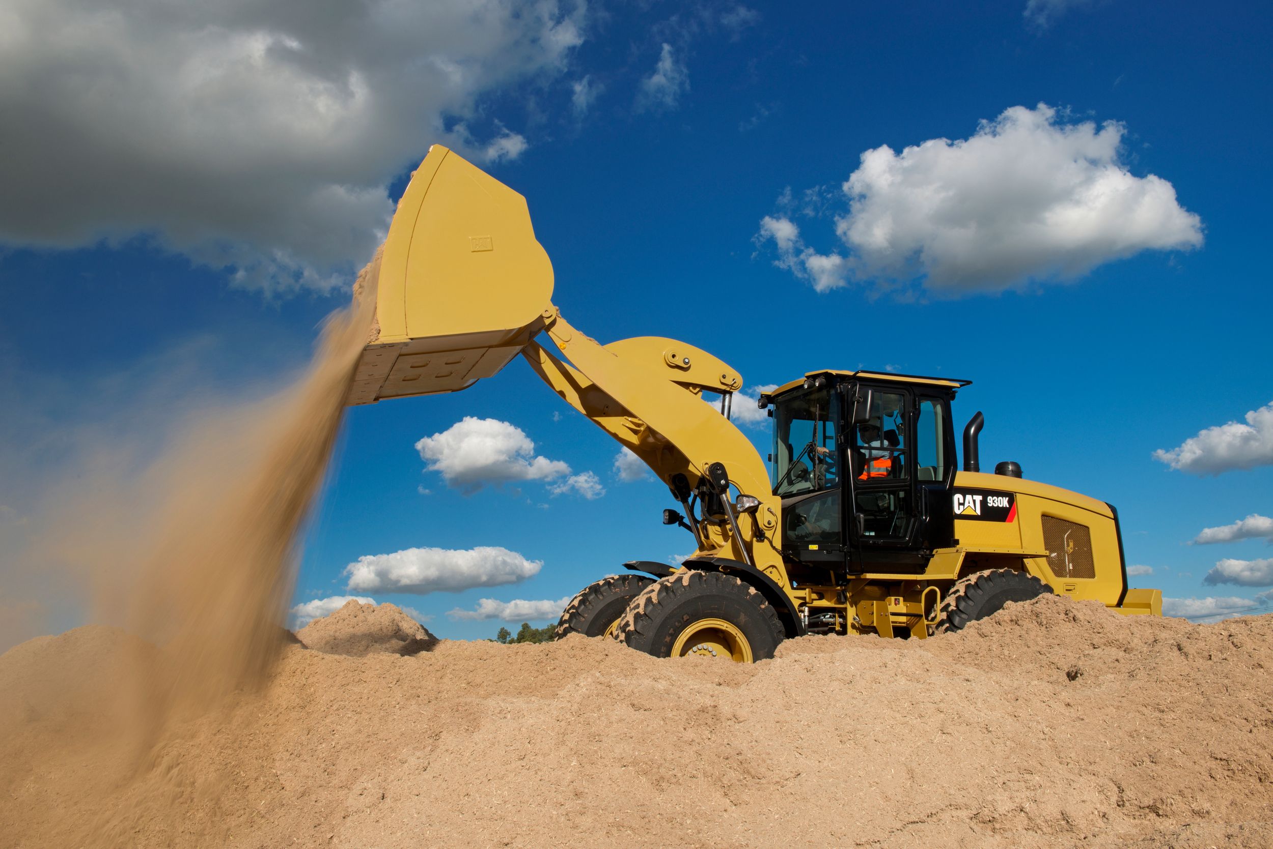 person performing maintenance on a small wheel loader