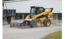 Cat® Utility Broom Sweeping and Collecting Debris