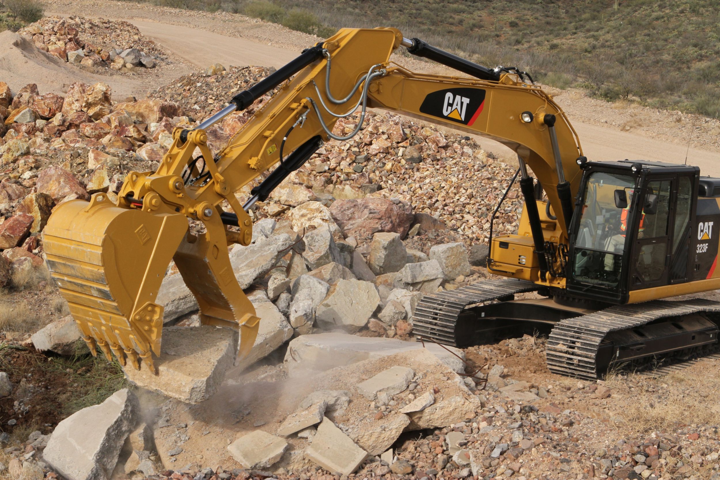 Site clean-up with Pin Grabber Coupler, Pro Plus thumb, and buck