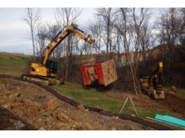 Using the lifting eye of the Pin Grabber Coupler to relocatte a trench box.