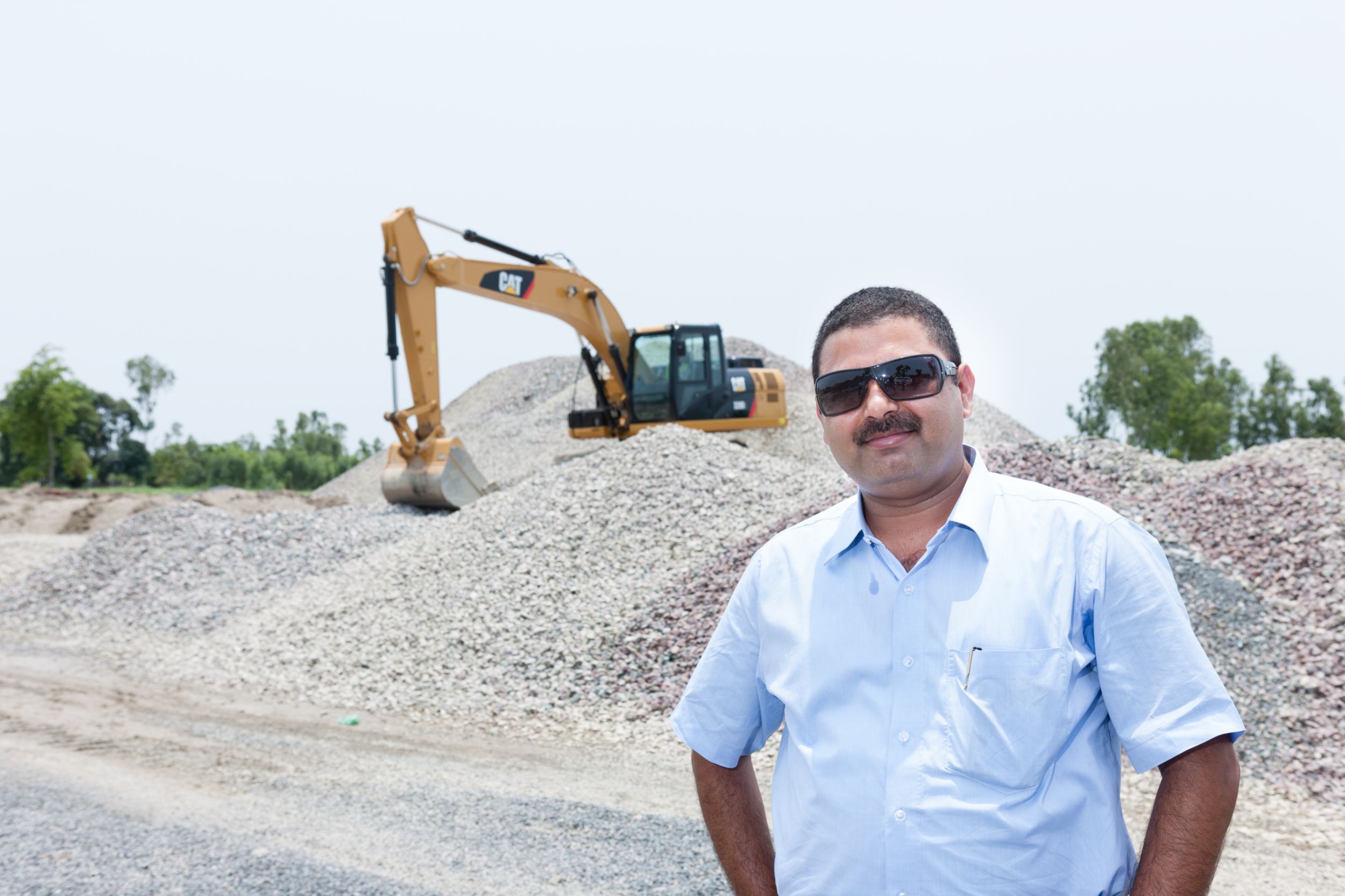 Two Caterpillar SME talking while seated
