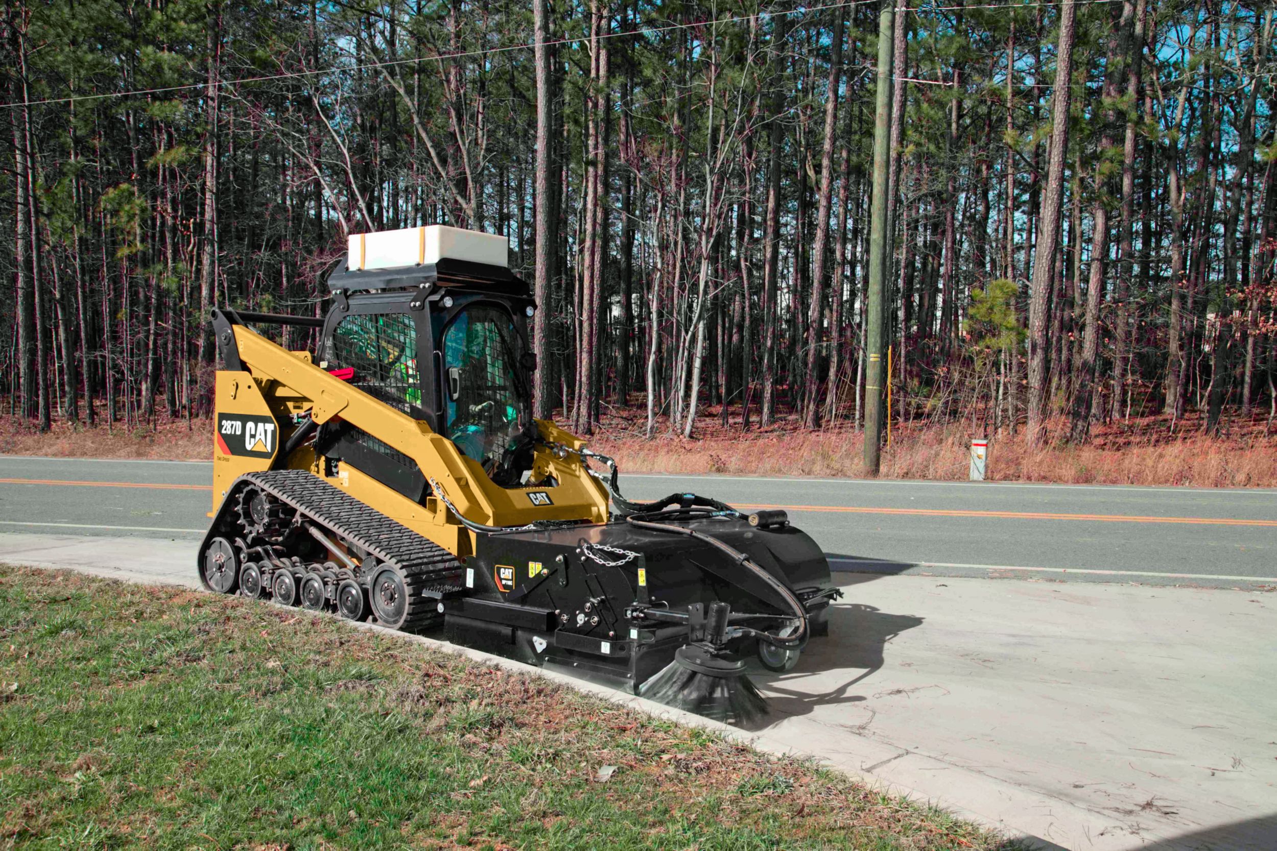 product-Cat® Pickup Broom at Work (shown with optional Dust Control Kit, Water Tank Kit and Gutter Brush)