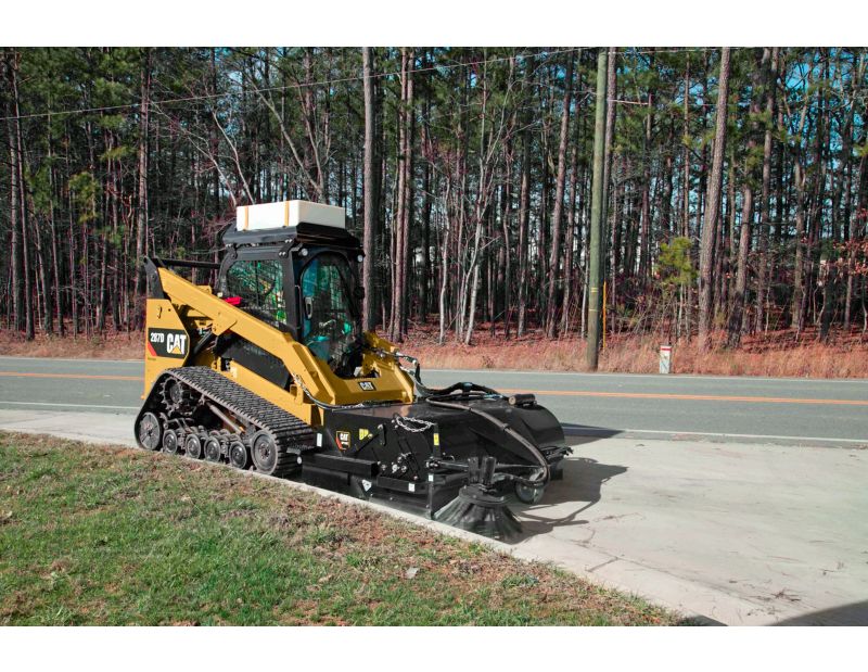 Cat® Pickup Broom at Work (shown with optional Dust Control Kit, Water Tank Kit and Gutter Brush)