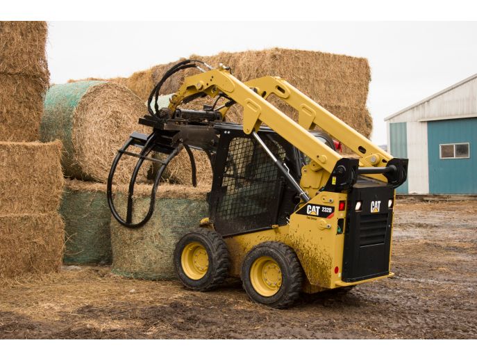 Cat® Bale Grab Picking Up a Wrapped Bale