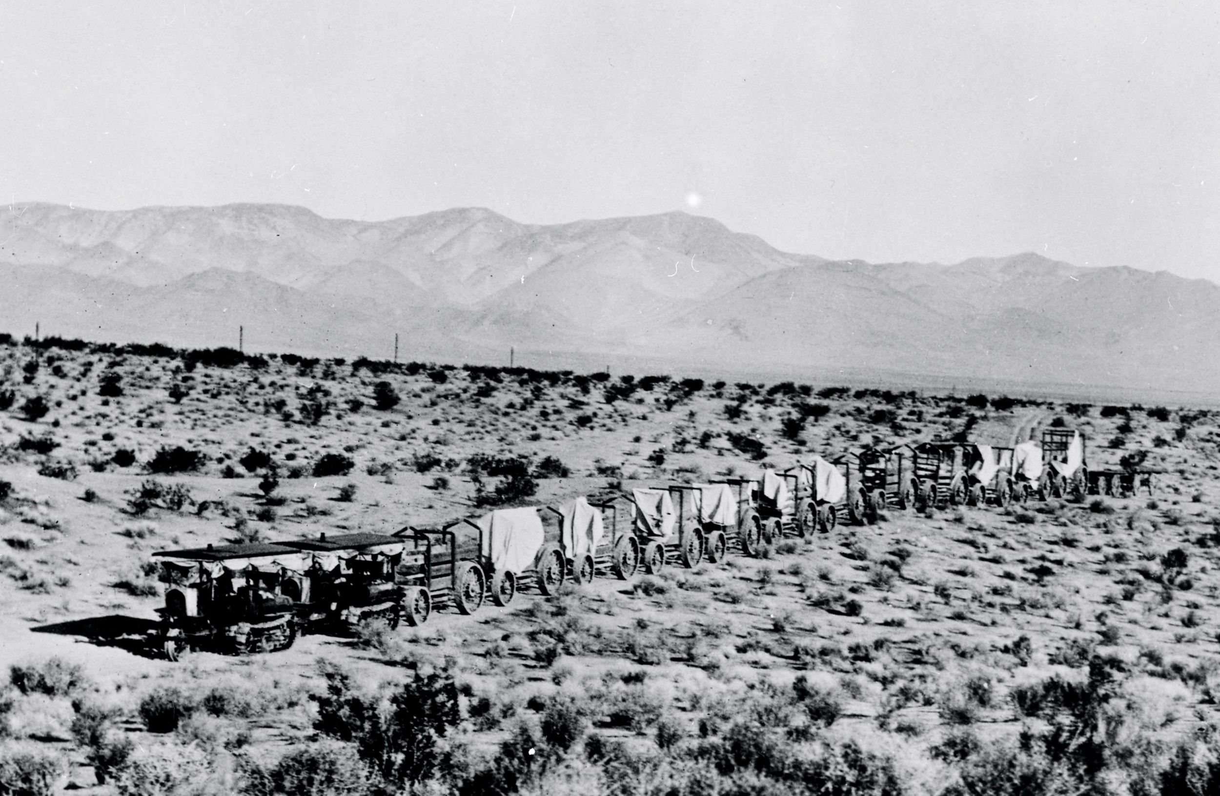 Holt Caterpillar gasoline powered track-type tractor pulling wagons during the construction of the Los Angeles Aqueduct.