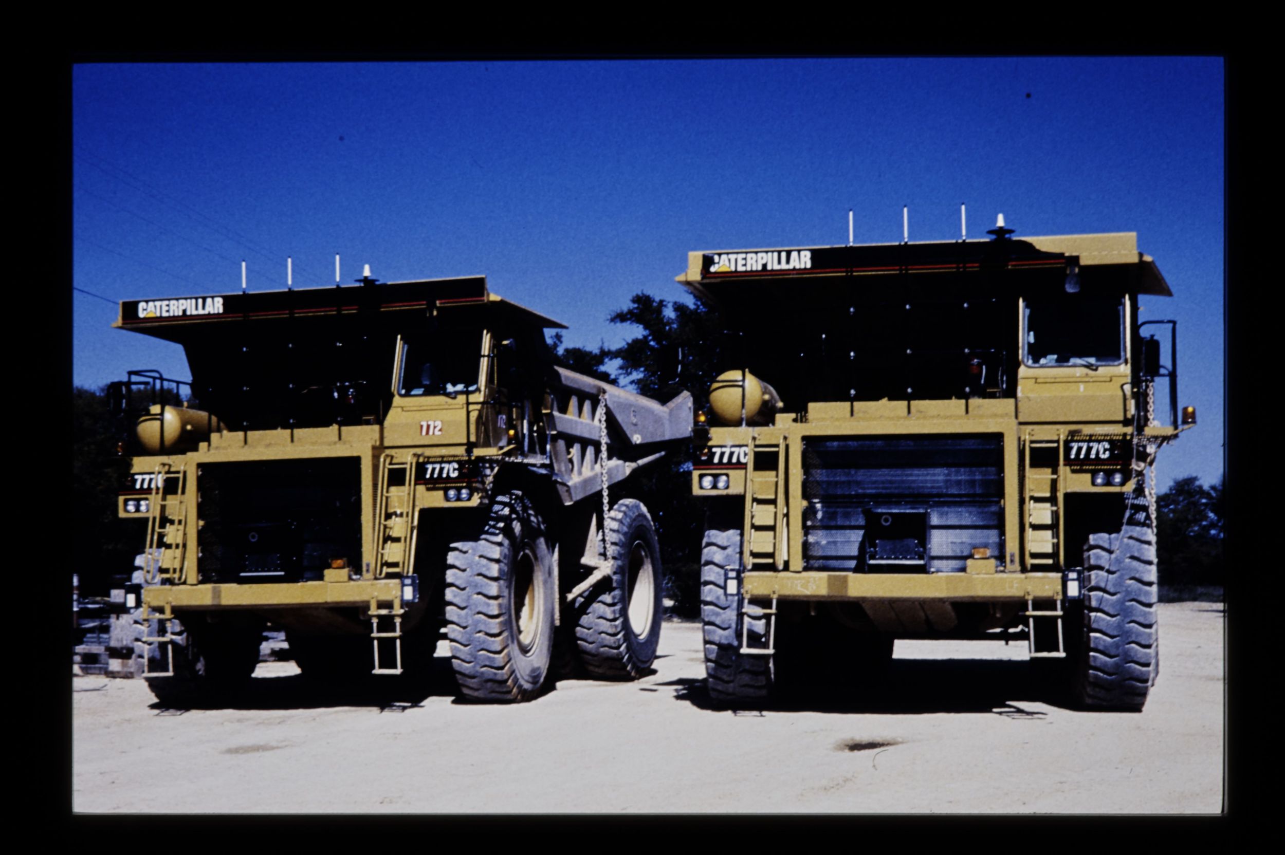 The first two prototype Cat 777C autonomous mining trucks at a Texas limestone quarry.