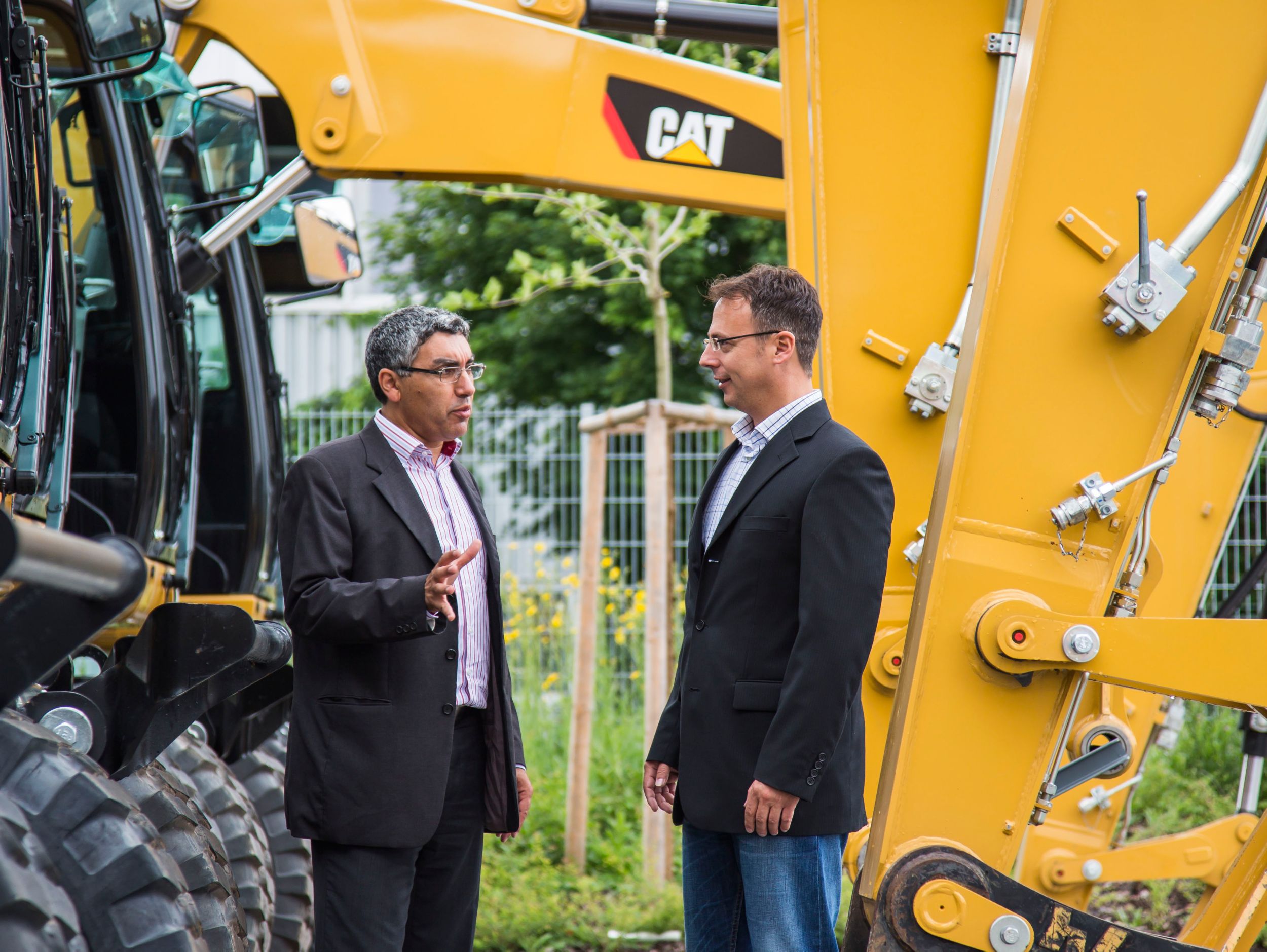 two men talking at dealership