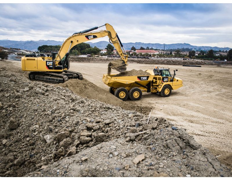 336F Excavator loading a 730C Articulated Truck with a General Duty Bucket