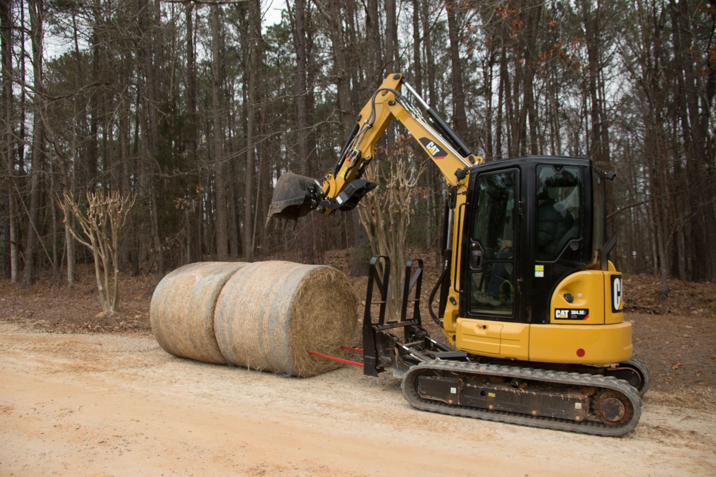 product-Cat® Bale Spear in use on a Cat 304.5E2