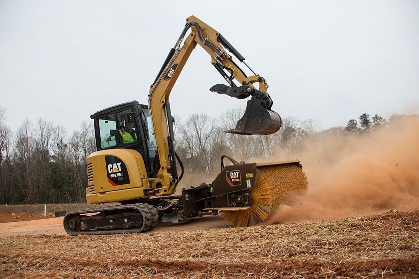 Cat® 304.5E2 XTC Mini Excavator sweeping with a BA118C Angle Broom