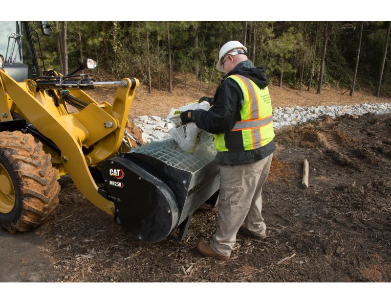 Customer Adding Mix to Cat® Mixing Bucket Using Integrated Bag Breakers